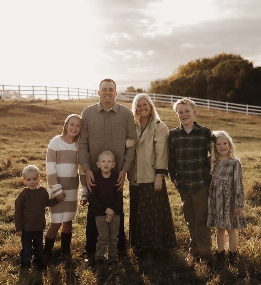 The Nemelka family outdoors, two parents with their five children.